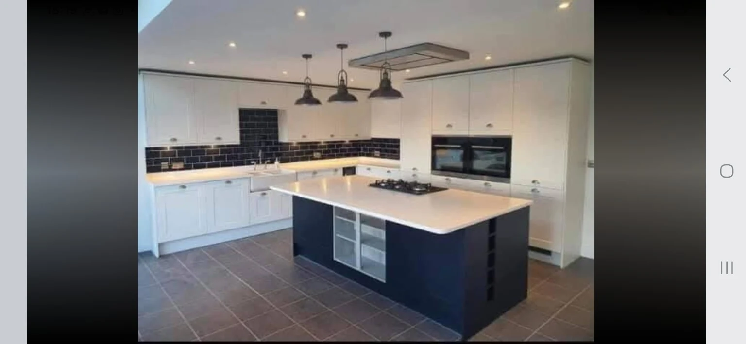 Completed white fitted kitchen with island by SM Installations