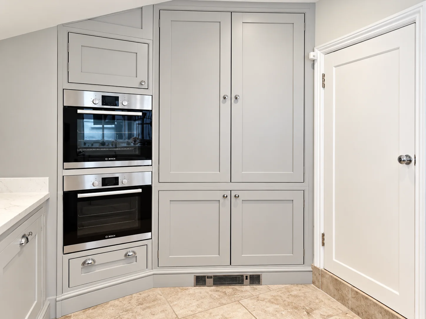 Grey fitted kitchen tall units with integrated appliances by SM Installations