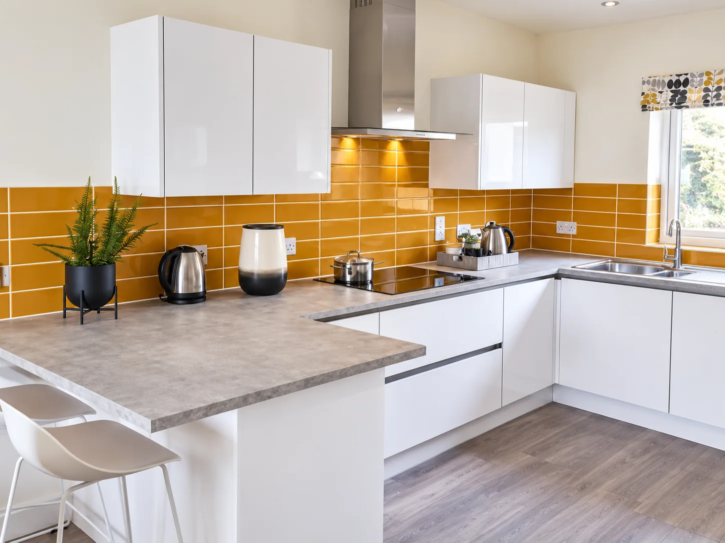White fitted kitchen with breakfast bar by SM Installations