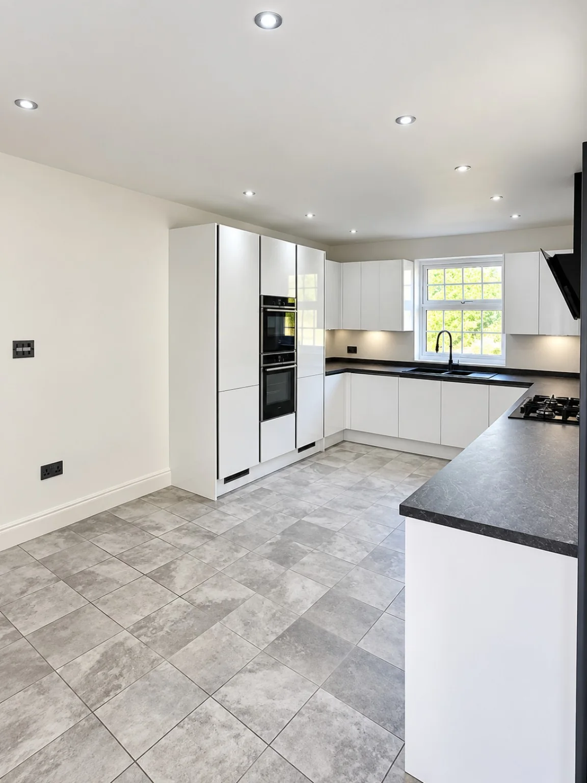 Modern white kitchen installation with peninsula by SM Installations